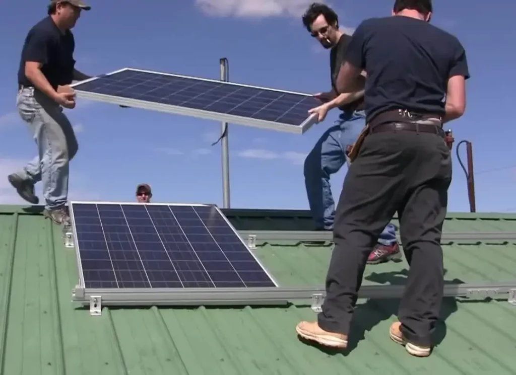 Workers lifting solar panel