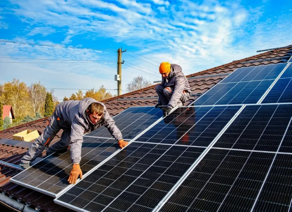 Technicians fitting solar panels